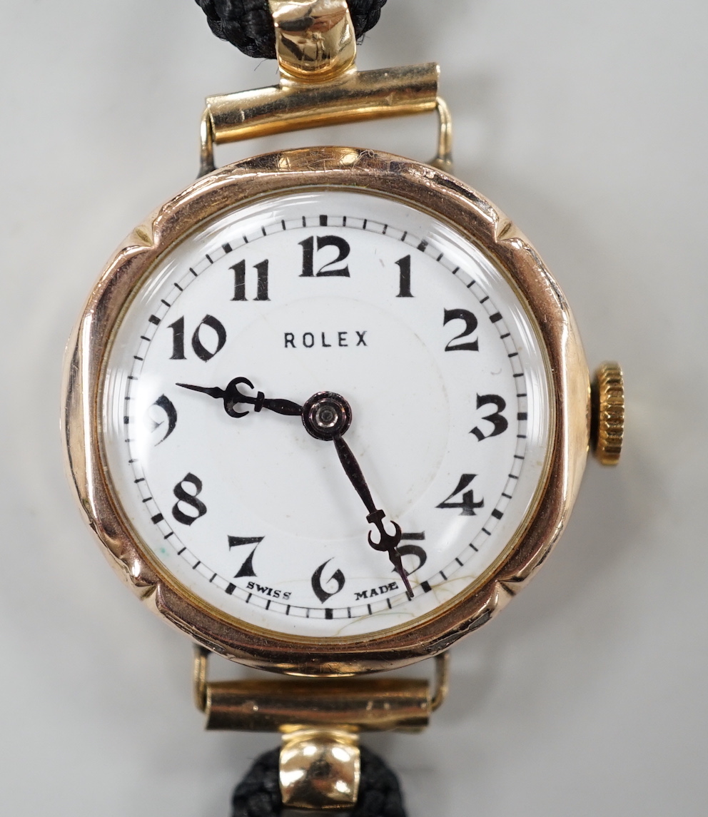 A lady's 1920's 9ct gold Rolex manual wind wrist watch, on associated fabric strap.